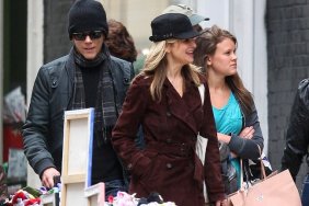 Kyra Sedgwick brown trenchcoat, black hat